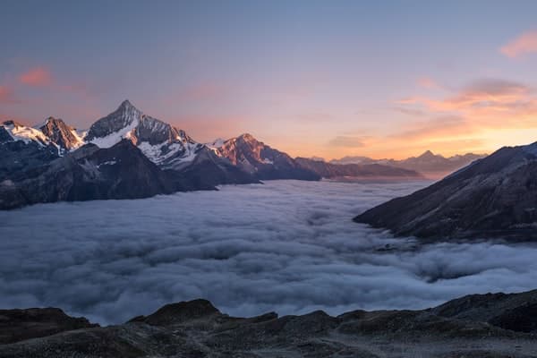 Mountain peak rising above the clouds — bold ambition